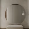 Frameless round bathroom mirror without a light and polished edge.