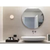Frameless round bathroom mirror without a light and polished edge.